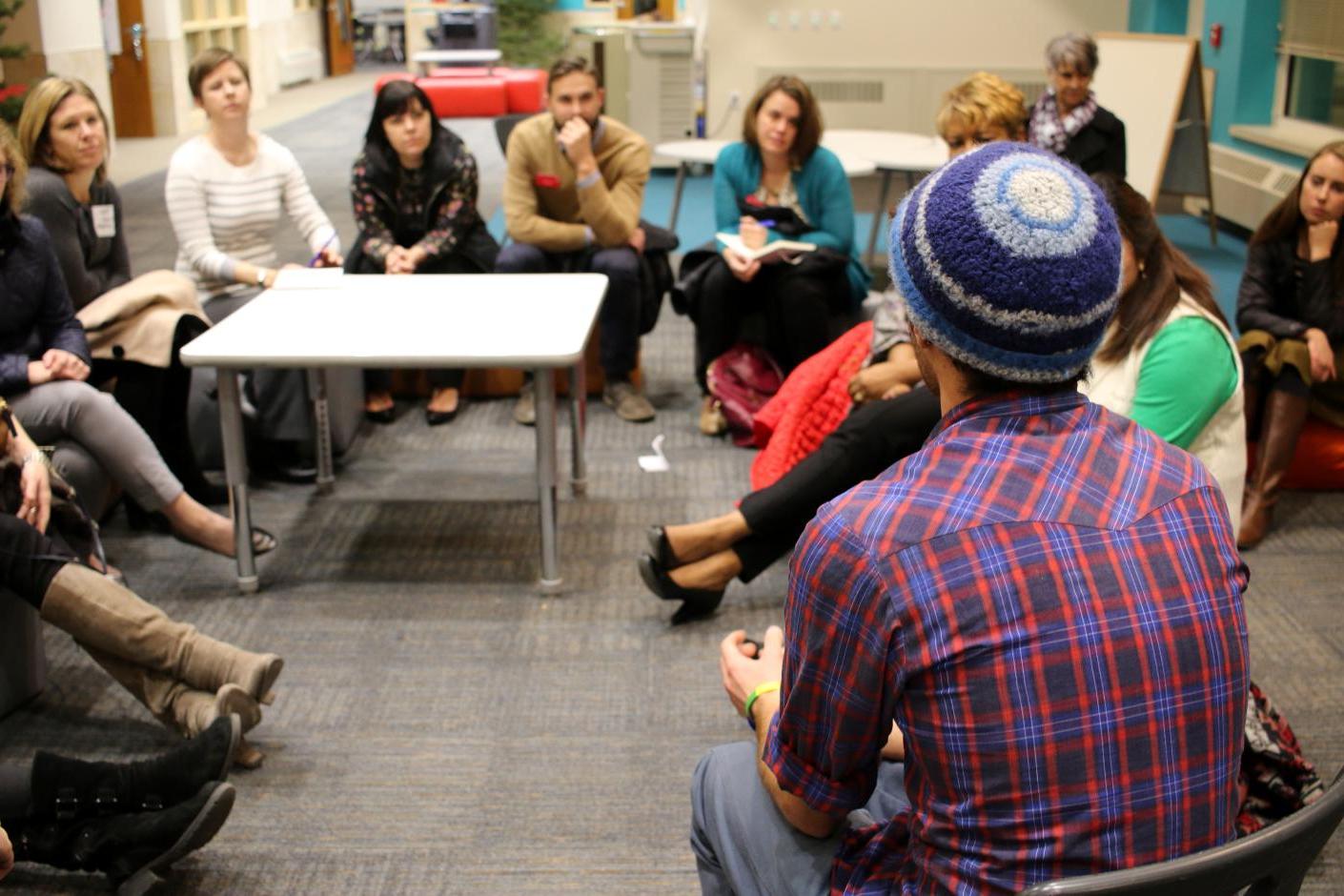 Group of people talking in a circle.